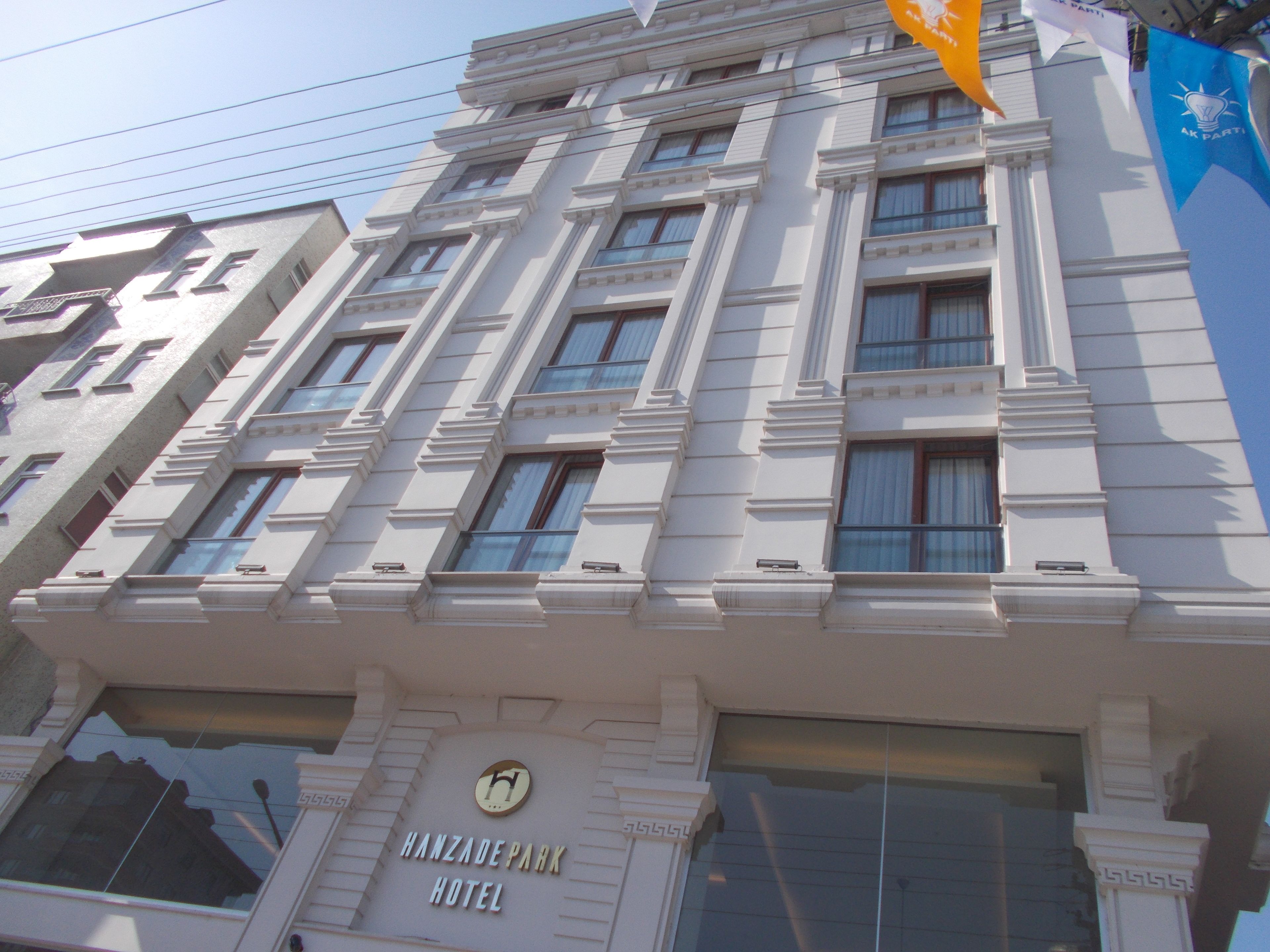 A multi-story building with a classical architectural style, featuring a prominent sign for the Hanza Park Hotel.