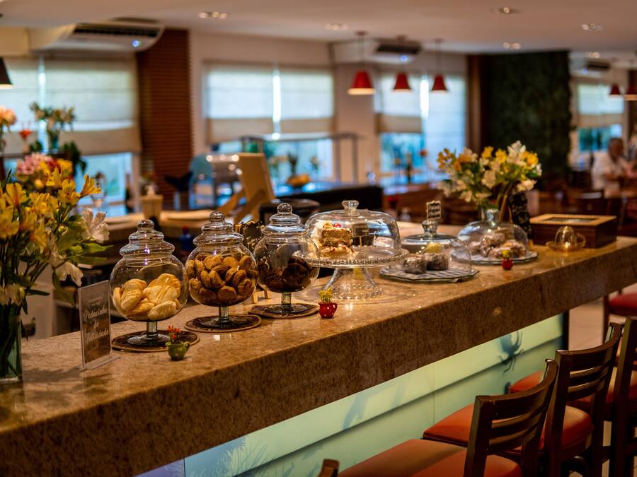 A buffet counter with various food items and a sign indicating 'Pâtisserie'.