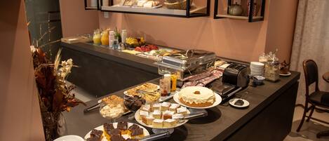 A buffet with various desserts and beverages.