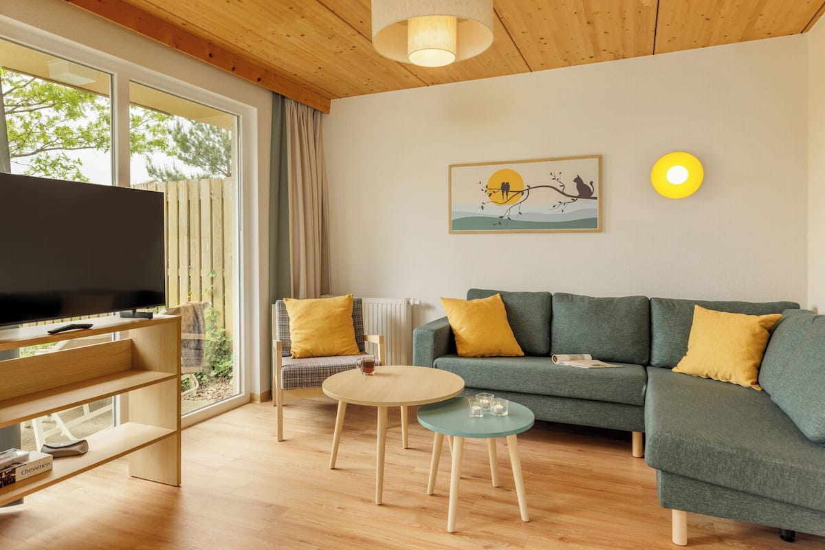 A living room with a television, sofa, and coffee table.