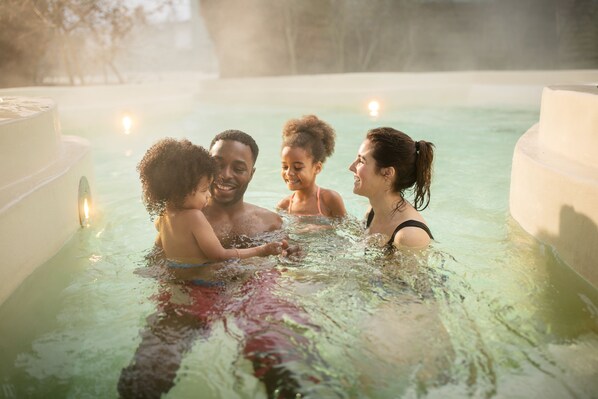 Guests can unwind in a serene outdoor setting with a hot tub.