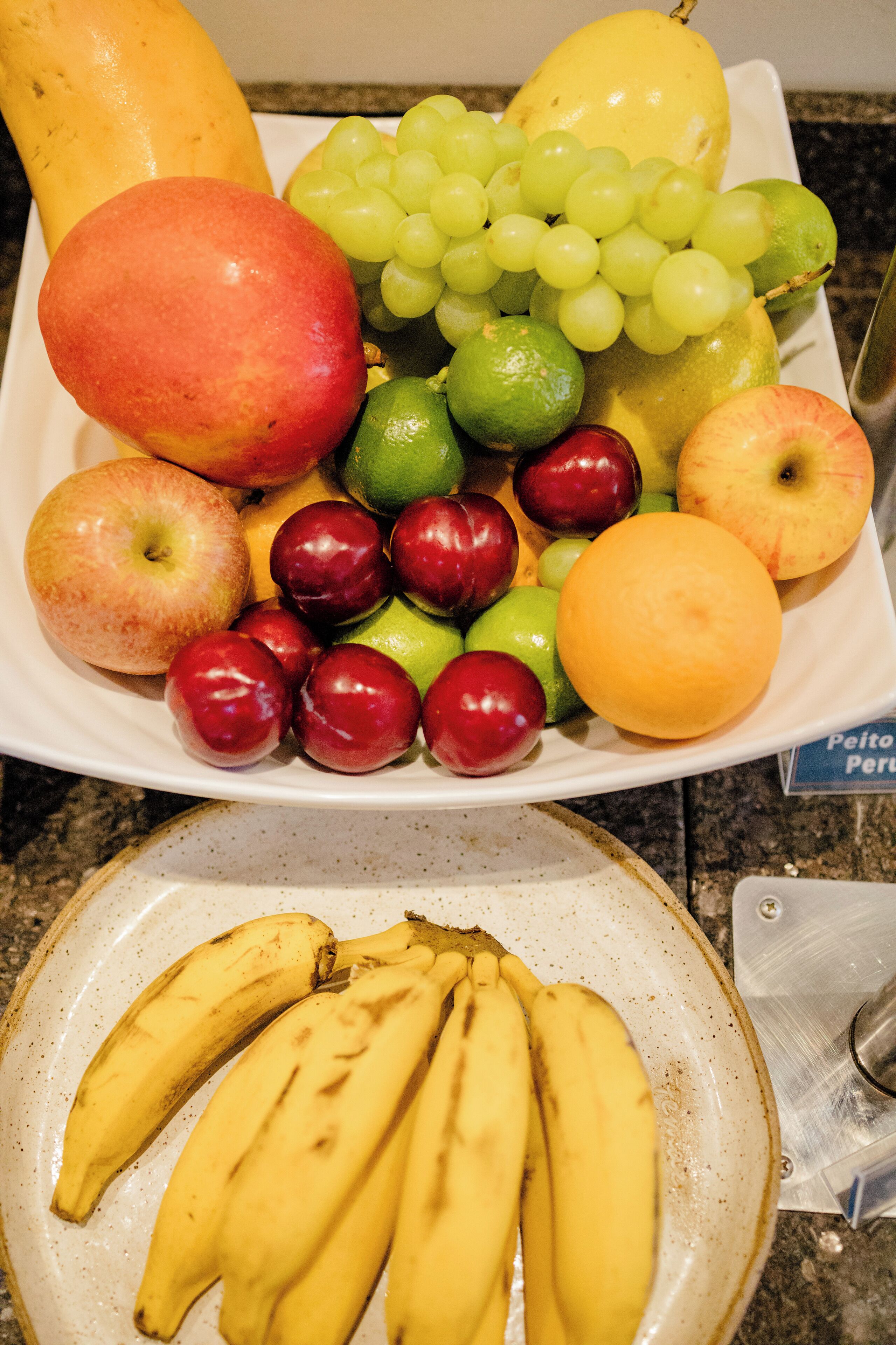 A fruit platter with various fruits including apples, grapes, and bananas.