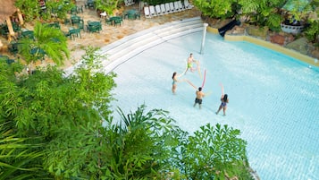 Relax by the pool surrounded by lush greenery and enjoy easy access to the water via the slide.