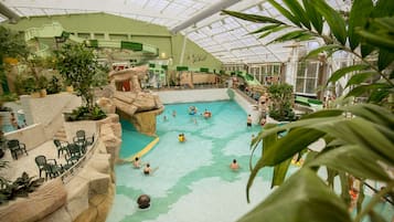 Relax by the pool surrounded by seating areas and lush greenery.