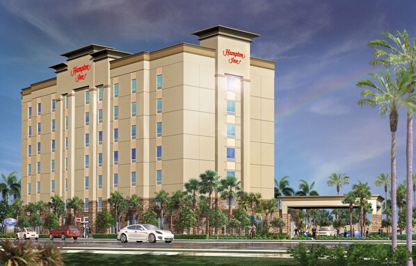 Un hotel Hampton Inn de diseño moderno, con varios pisos y una entrada destacada.
