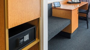 A Minibar with a television, desk, chair, and a remote control on the floor. - Best Western Hotel Kaiserslautern (Kaiserslautern)