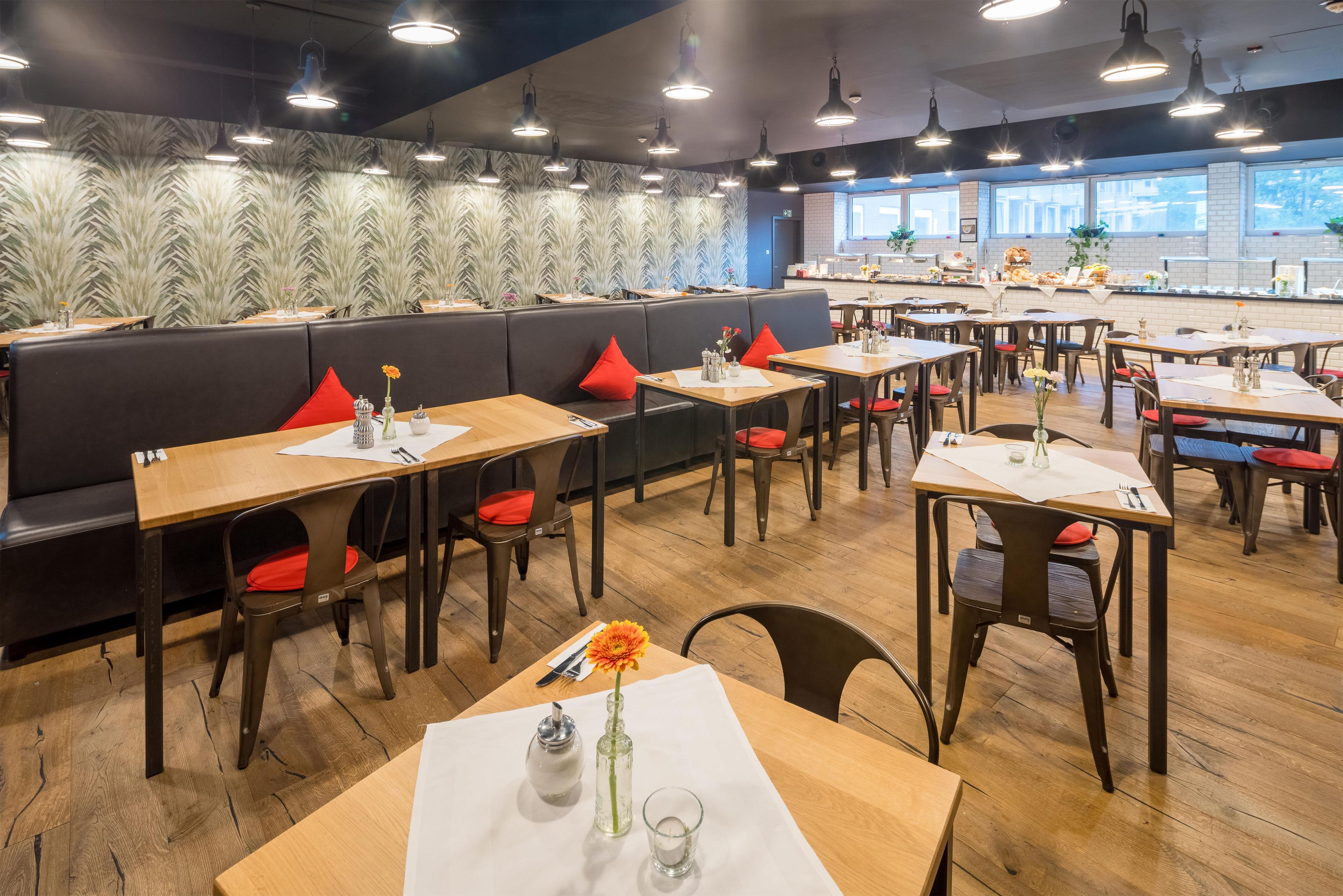 A restaurant with booths, tables, and a counter area.