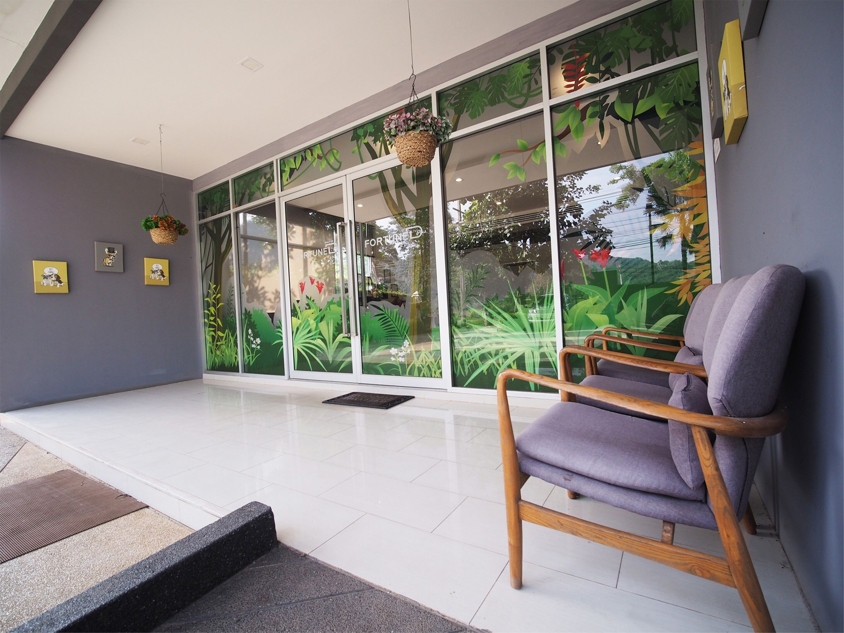 A modern interior with a large glass wall, a wooden chair, and a small rug.