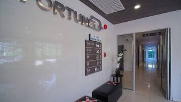 A reception area with a 'FORTUNE' sign, directional signs, and a hallway leading to other parts of the building.