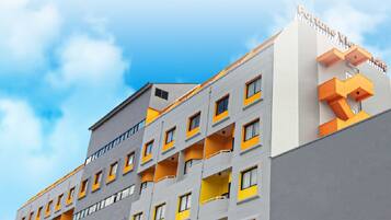 Experience the unique architecture of Fortune View, featuring a striking facade with balconies and a flat roof.