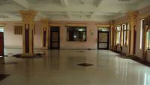 A spacious hallway with columns, doors, and windows. - Nepal Yoga Retreat (Changunarayan)
