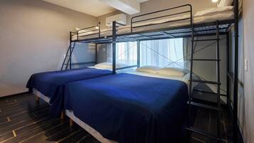 Habitación con literas, una escalera y una ventana con cortinas.