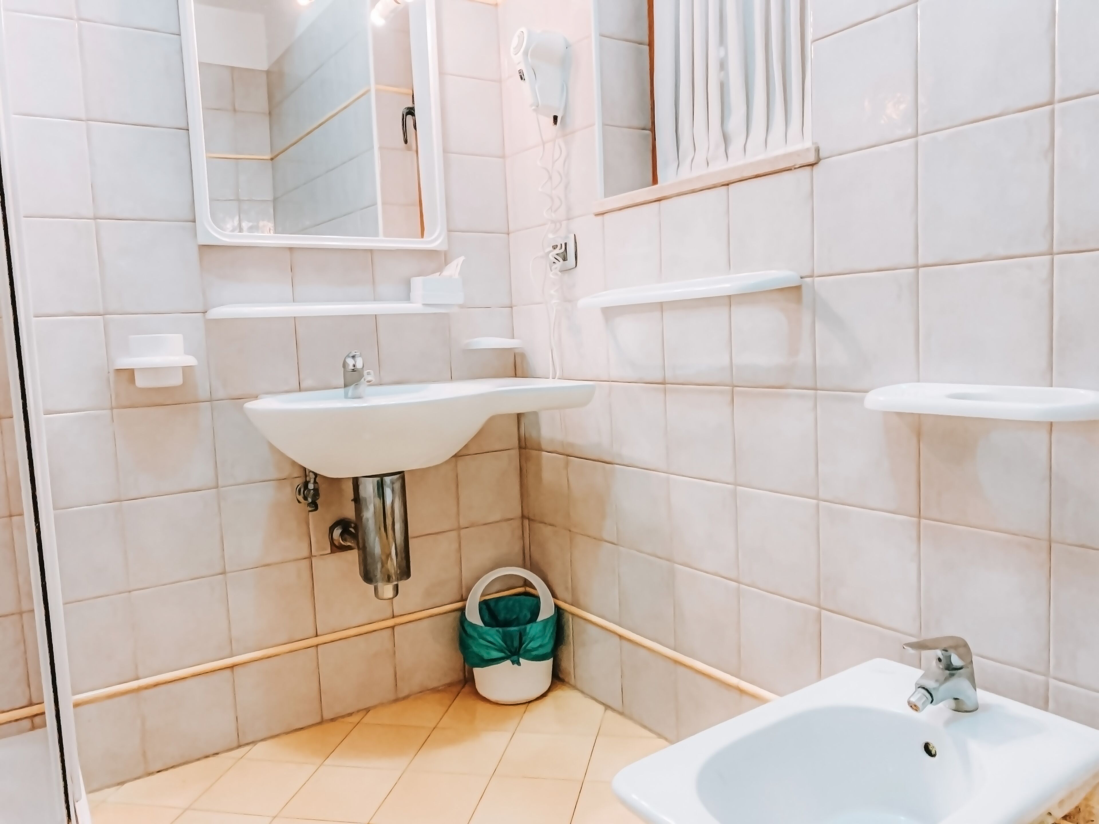 A bathroom with a sink, mirror, and toilet.