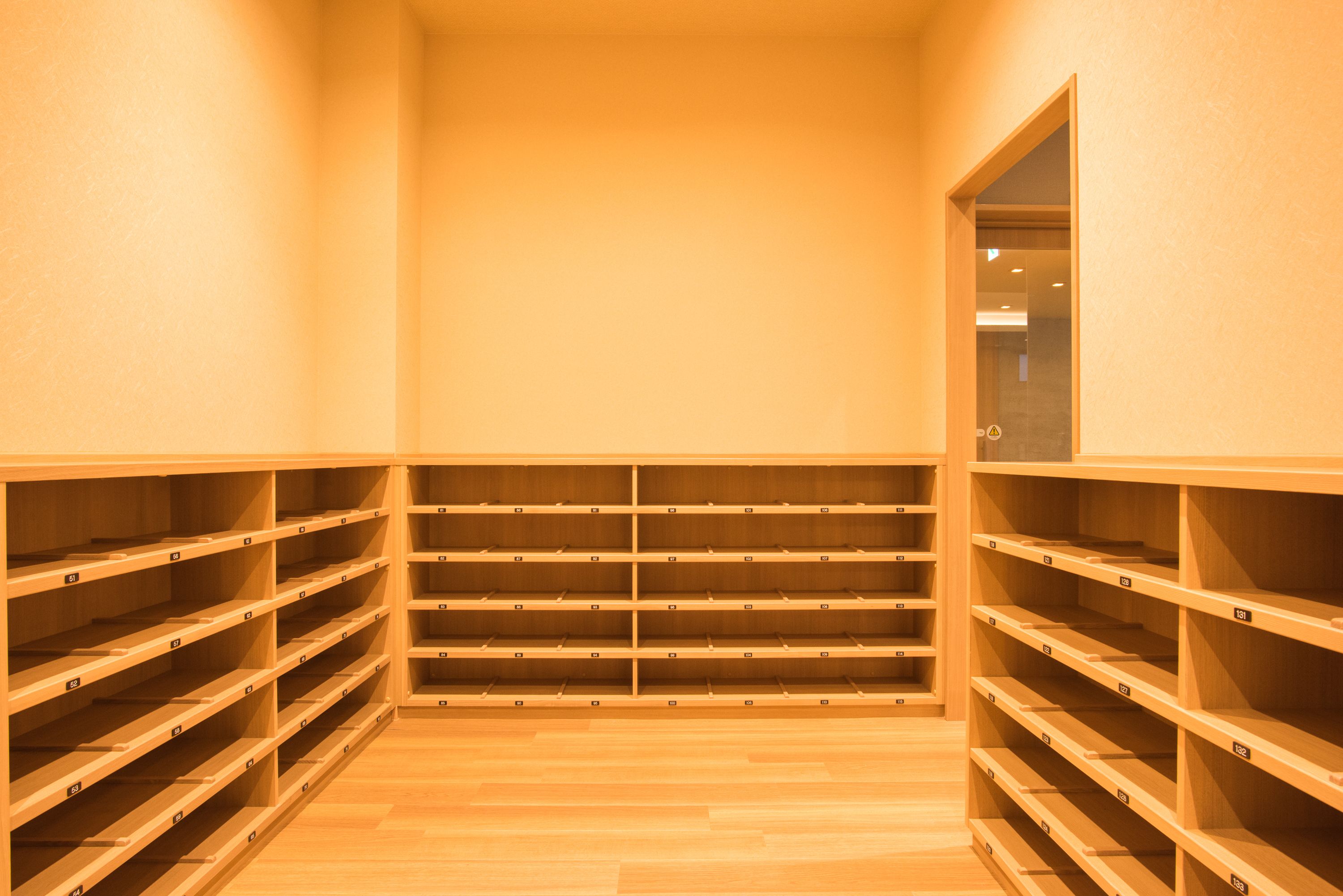 A storage room with wooden shelves and a wooden floor.