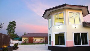 A two-story residential building with a flat roof, large windows, and a balcony. - Baan Maesot Boutique Resort (Mae Sot)