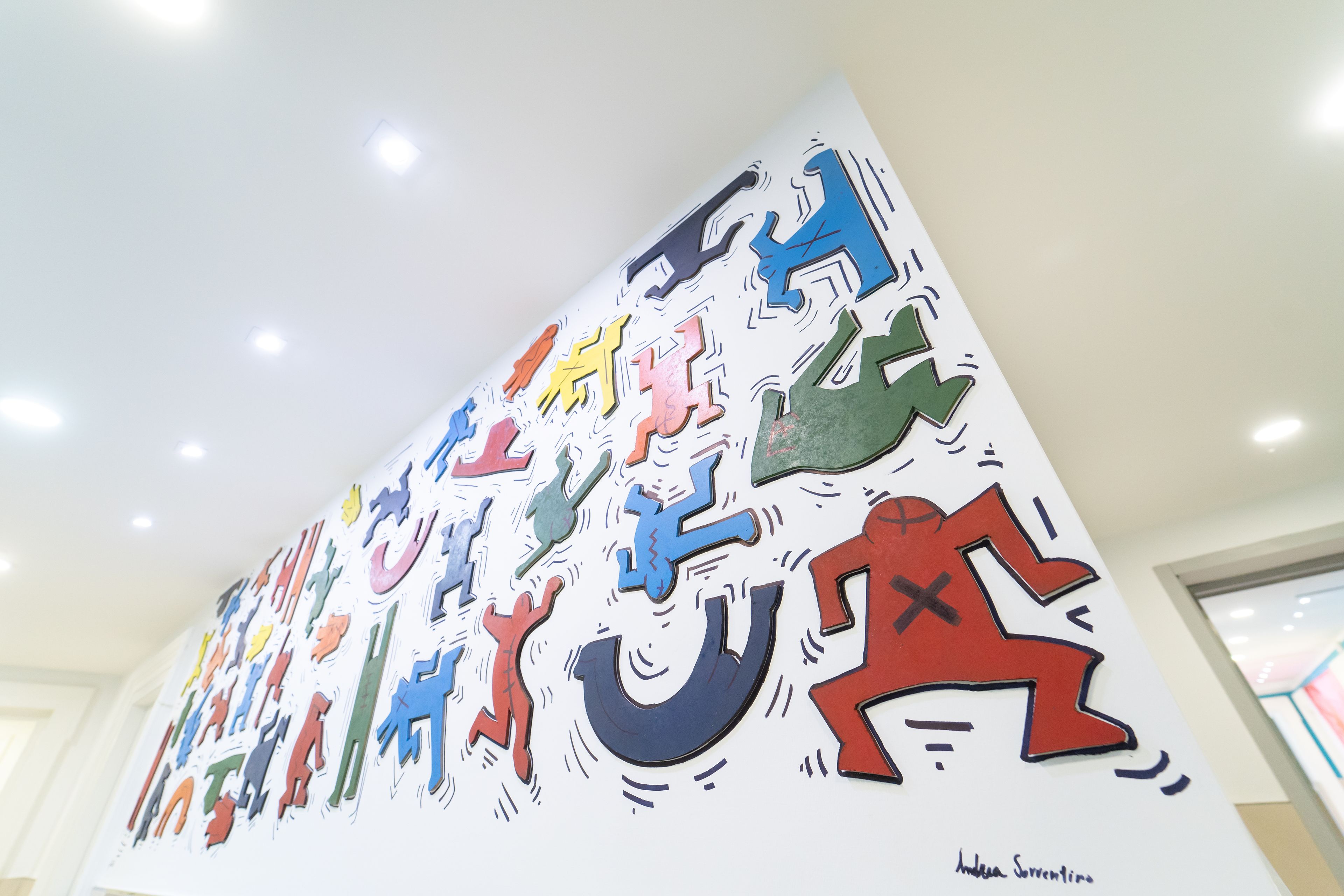 A wall with colorful cut-out shapes and figures.