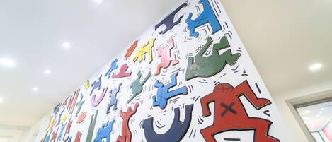 A wall with colorful cut-out shapes and figures.