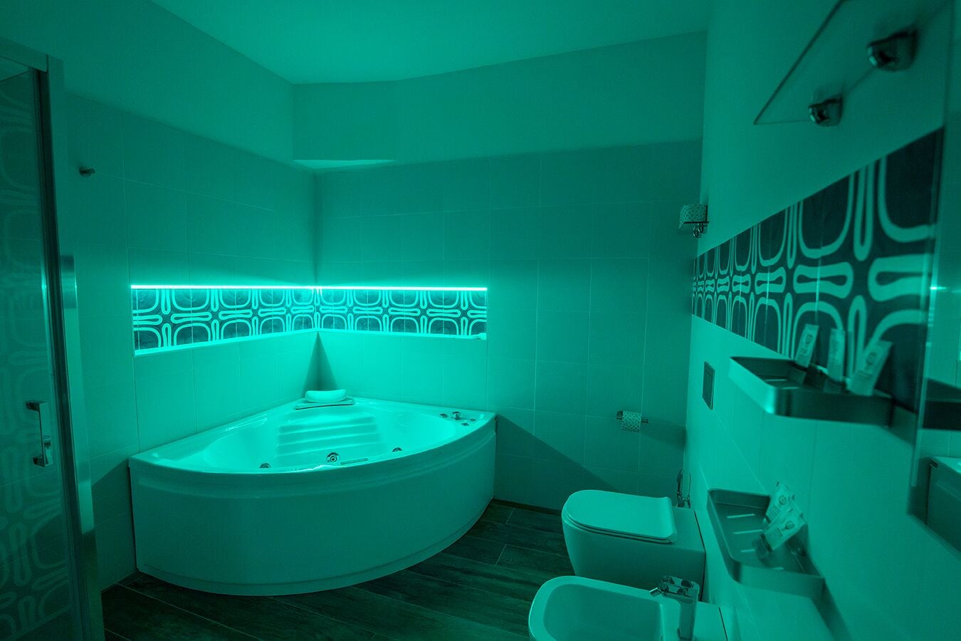 A modern bathroom with a freestanding bathtub, a toilet, and a bidet.