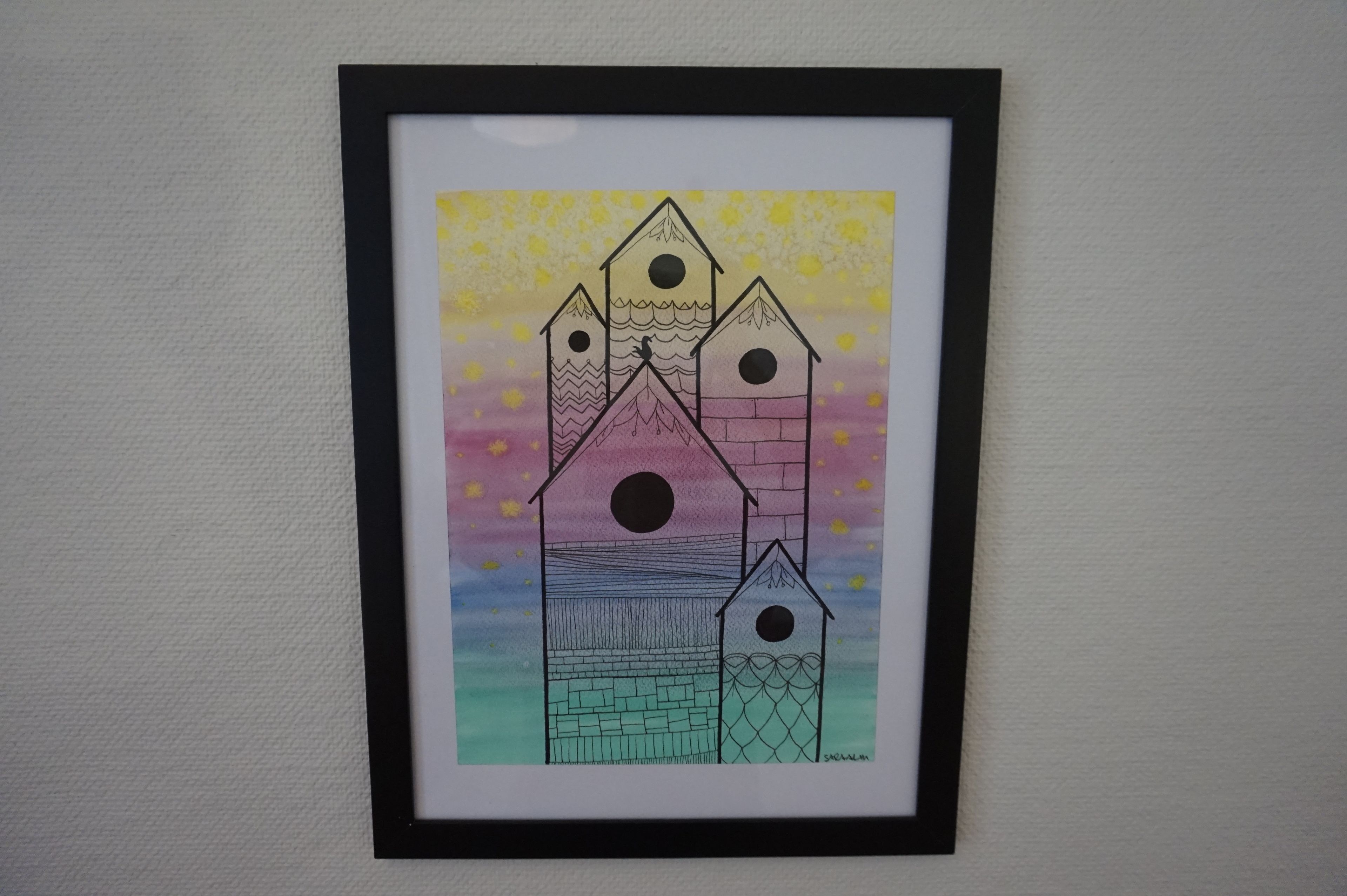 A framed drawing of a multi-tiered building with a starry background.