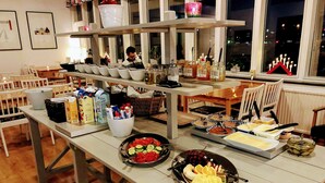 Uma mesa de buffet com diversos alimentos e bebidas.