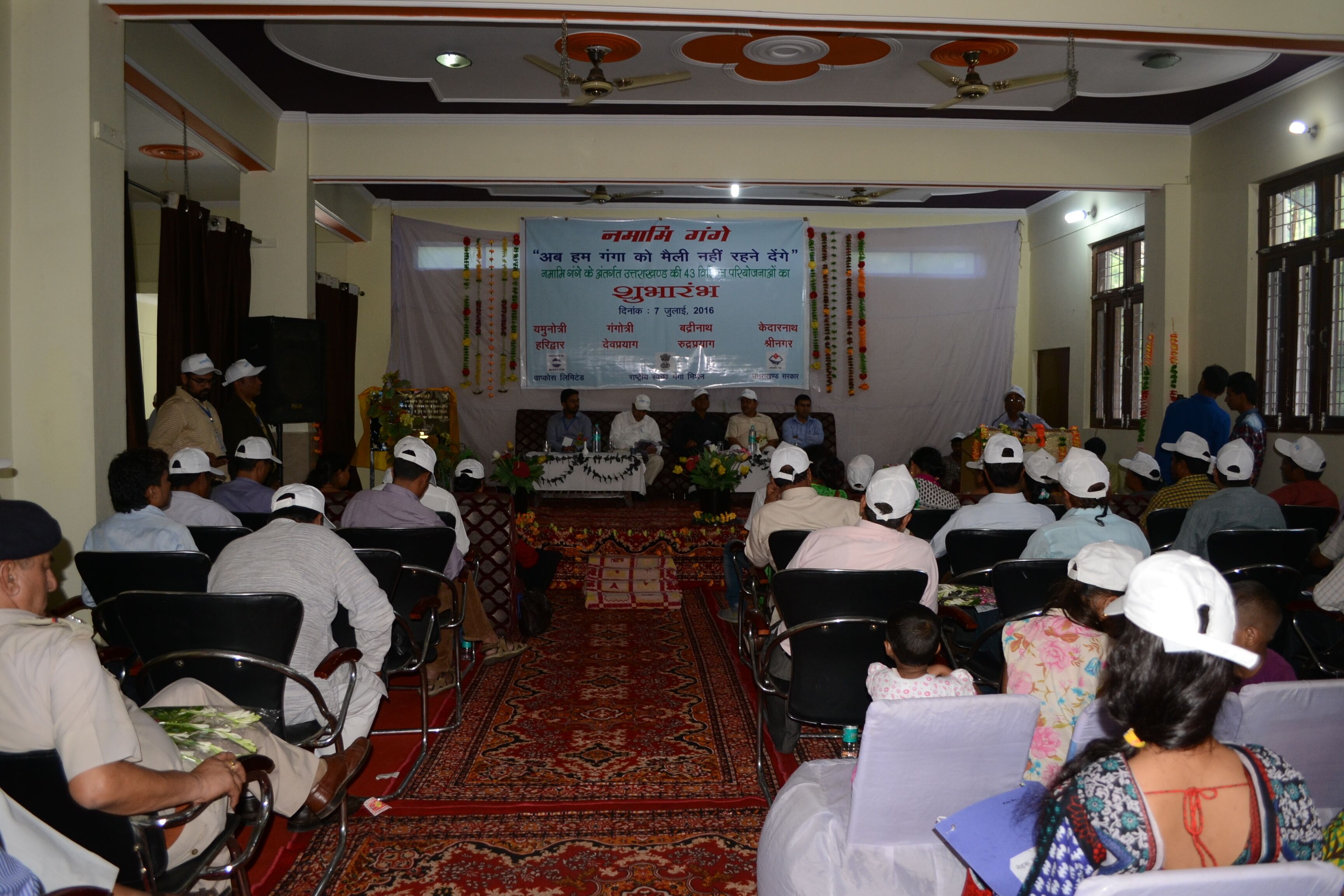 A conference room with rows of chairs facing a stage with a banner.
