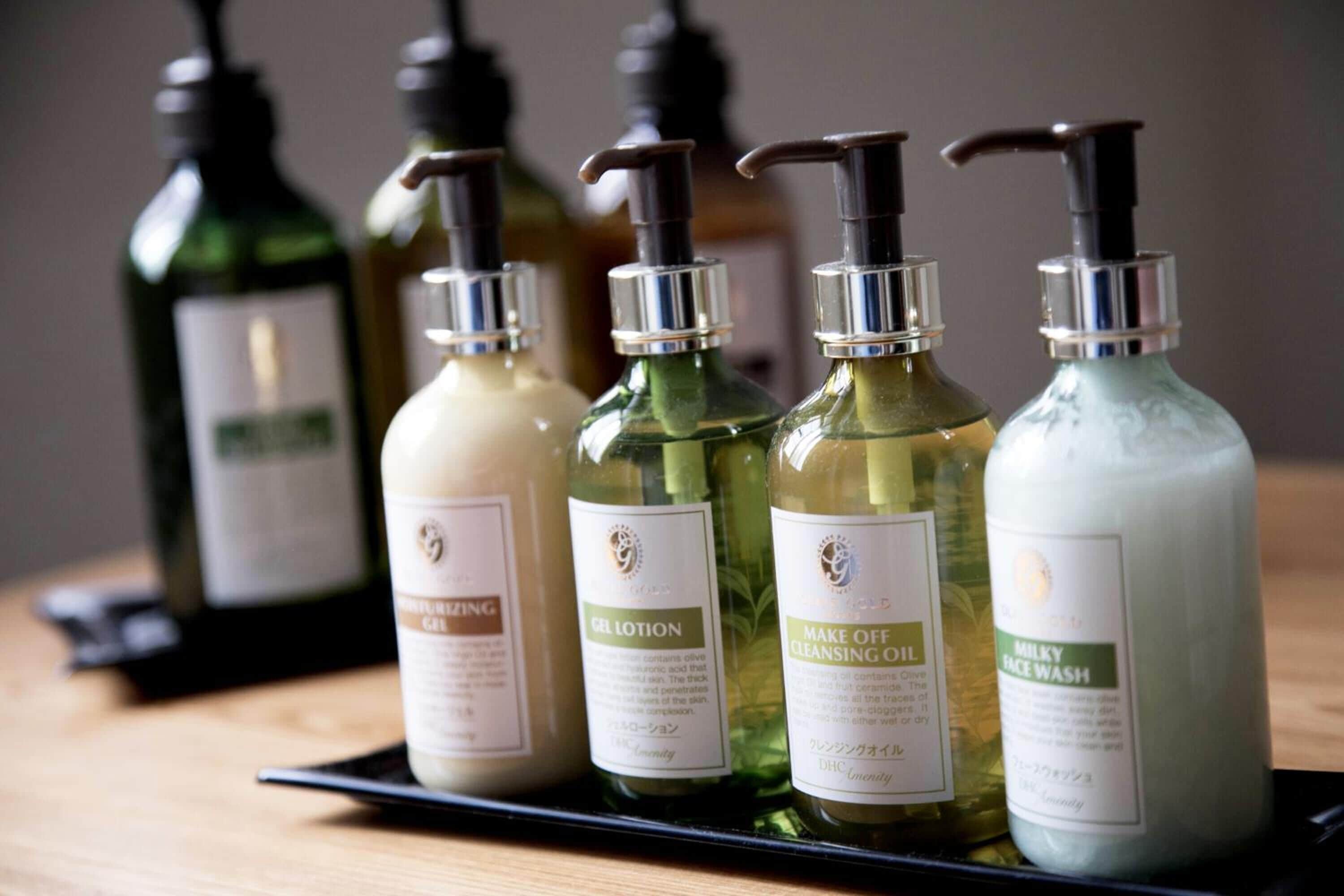 A display of four bottles of skincare products on a black tray.