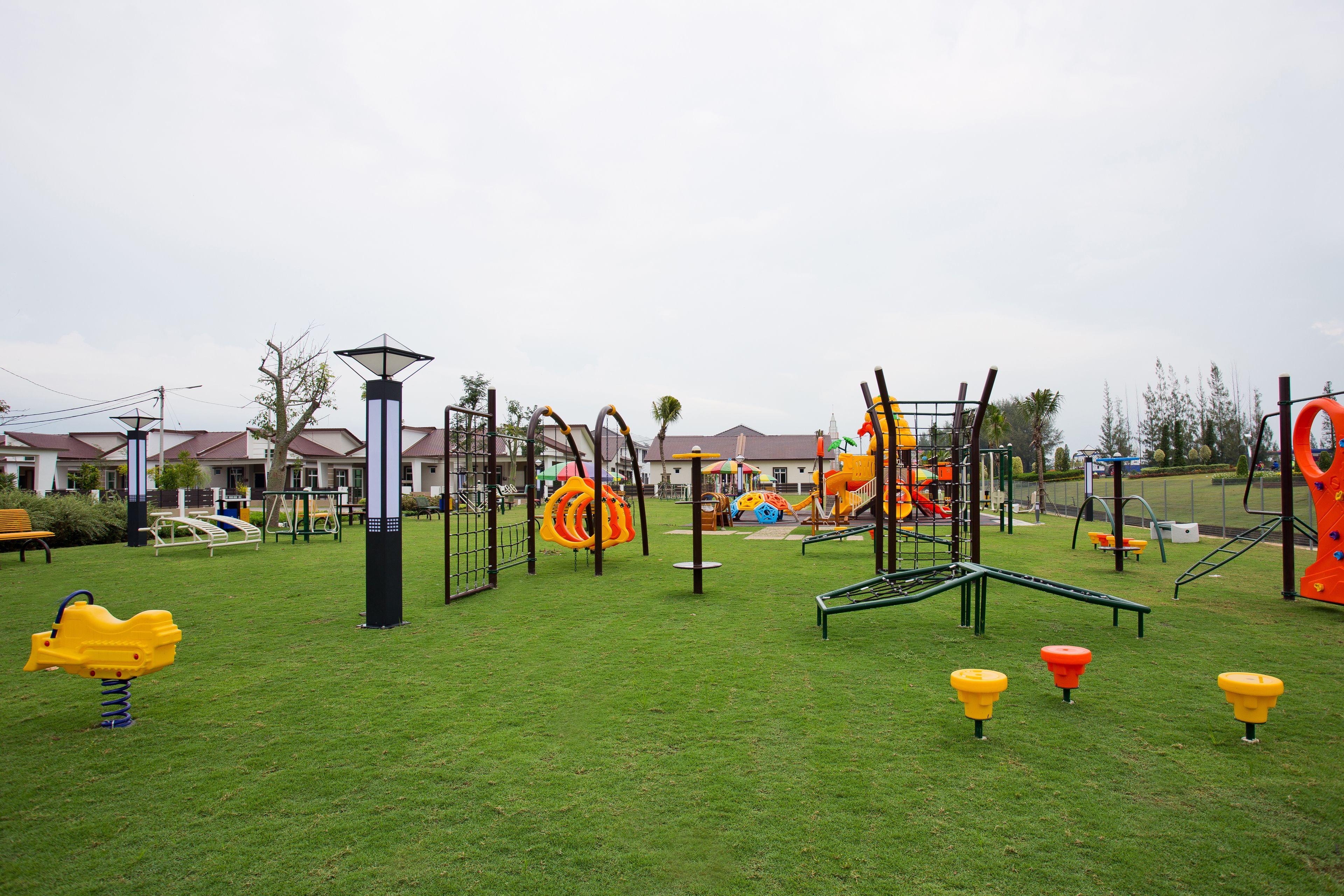 A playground with various play structures and a bench.