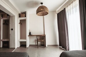 A modern room with a desk, chair, and a hanging woven light fixture. - Art Alacati (Cesme)