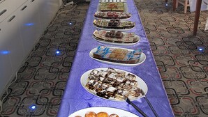 A buffet setup with various food items and a long table. - Kadikoy Arya Hotel (Istanbul)
