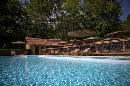 Seasonal outdoor pool, open 8:00 AM to 8:00 PM, pool umbrellas
