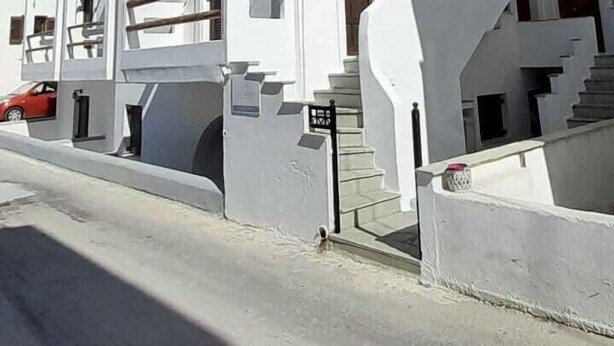 A modern two-story building with a flat roof and a prominent staircase leading to the entrance. - Depis Apartments 2 (Naxos)