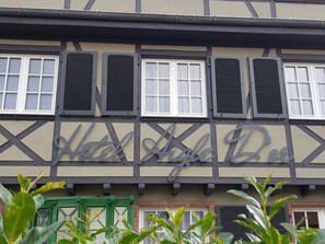 A building with a sign reading "Hotel Angel Bue." It features a traditional half-timbered facade with multiple windows, some with shutters. - Hôtel Aigle d'Or (Reichstett)