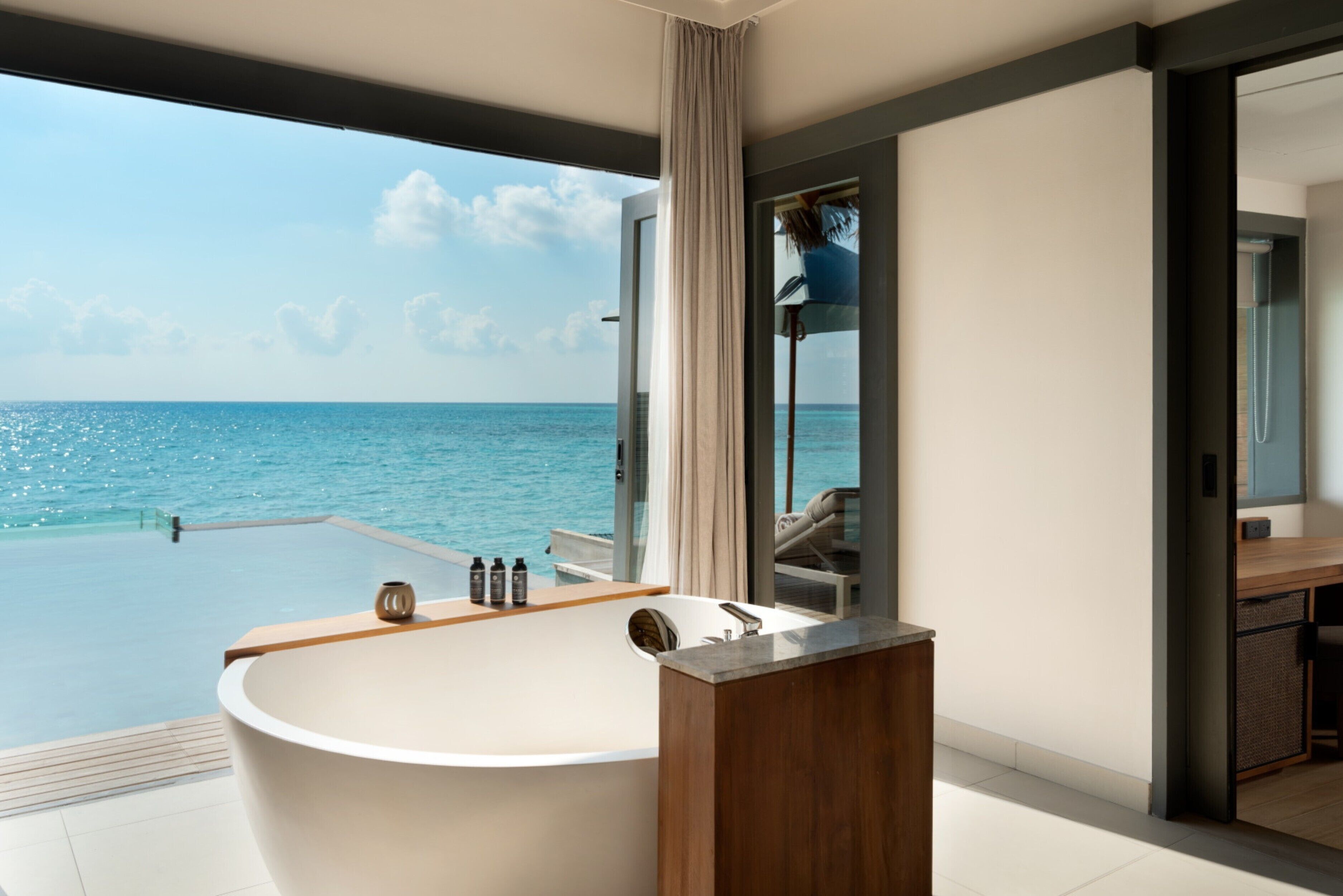 one bedroom over water pool residence:30% off seaplane transfers, 11 jan to 19 dec 2025 stay | bathroom | separate bathtub and shower, rainfall showerhead, free toiletries