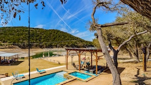 A pool area with two pools, a gazebo, and a view of a hilly landscape. - Lakefront/Pool & Hot Tub/NEW PICKLEBALL/Sand Volley Ball/4 acres/Sleeps 28 (Austin)