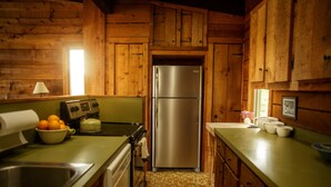 A kitchen with wooden cabinets, a stainless steel refrigerator, a stove, and a sink. - Reillys Rest-private home in Green Mtns, kid-pet friendly-Ski,Bike,Walk,Relax! (Weston)