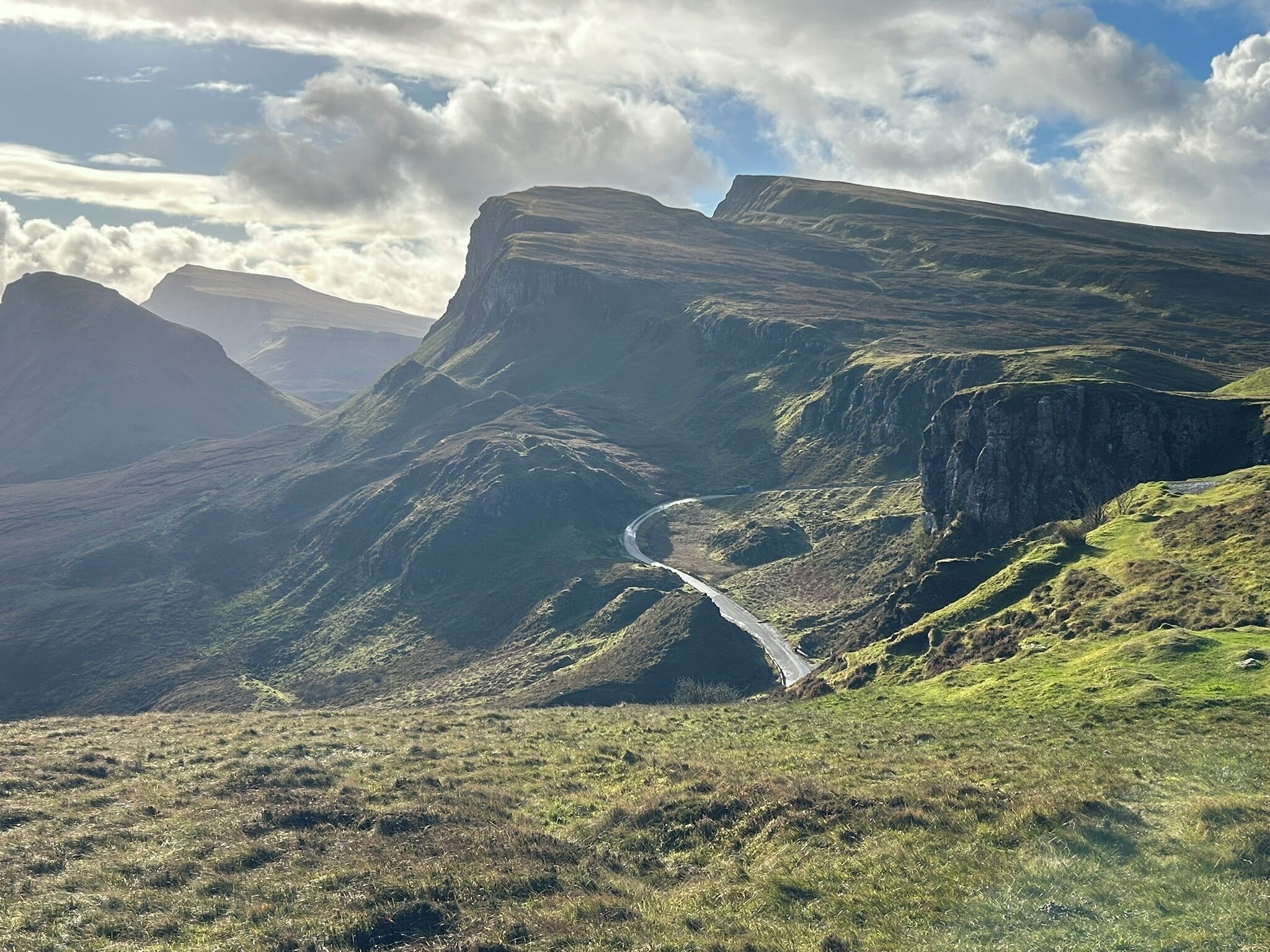 A mountainous landscape with a winding road.