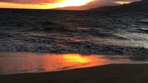 A sunset over a beach with waves and clouds. - Tropical 2-BR Condo + Pool +  Hot Tub! 
CHECK OUT OUR SPRING 2026 SPECIALS (Kihei)