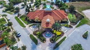 An aerial view of a large, multi-story building with a red-tiled roof, surrounded by well-maintained gardens and a central fountain. - Stunning Luxury 6 bed 5.5bath  Pool Villa Nr Disney Golf Games Room gated resort (Davenport)