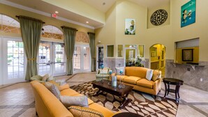 A spacious lobby with a large sofa, a coffee table, and a fireplace. - Stunning Luxury 6 bed 5.5bath  Pool Villa Nr Disney Golf Games Room gated resort (Davenport)