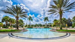 A swimming pool surrounded by palm trees and lounge chairs. - Stunning Luxury 6 bed 5.5bath  Pool Villa Nr Disney Golf Games Room gated resort (Davenport)