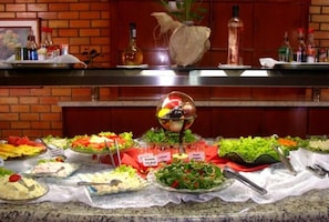A buffet with various dishes and condiments.