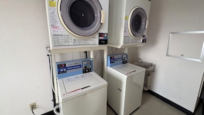 A laundry facility with three washing machines and a sink. - APA Hotel Saitama Ageo Ekimae (Ageo)