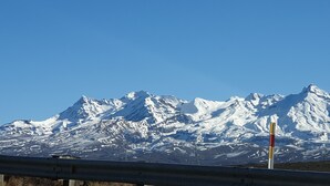 A snow-covered mountain range with a clear sky.