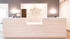 A reception desk with a sign reading "MICROTEL by Wyndham." - Microtel Inn & Suites by Wyndham Springville/Provo (Springville)