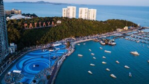 A marina with numerous boats, a large sign reading "PATTAYA city", and a backdrop of high-rise buildings and a forested area. - Baan Pattaya by Sabai (Pattaya)