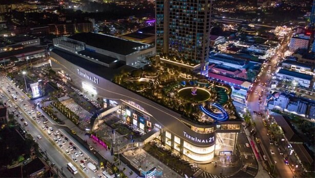 A modern hotel with a prominent 'Terminal 21' sign, surrounded by a well-lit urban area with roads and other buildings. - Baan Pattaya by Sabai (Pattaya)