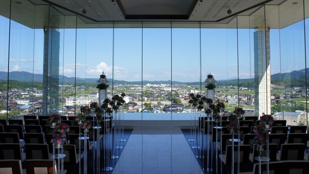 A modern venue with a clear view of a cityscape through large windows. - Centrale Hotel Kyotango (Kyotango)
