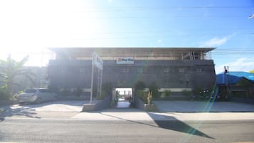A building with a sign for 'Cing-Cing Hotel' and a covered entrance.