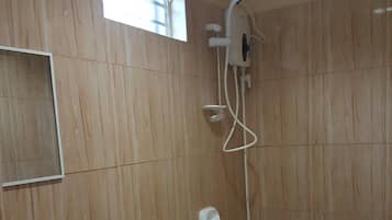 A bathroom with a toilet, sink, and shower.
