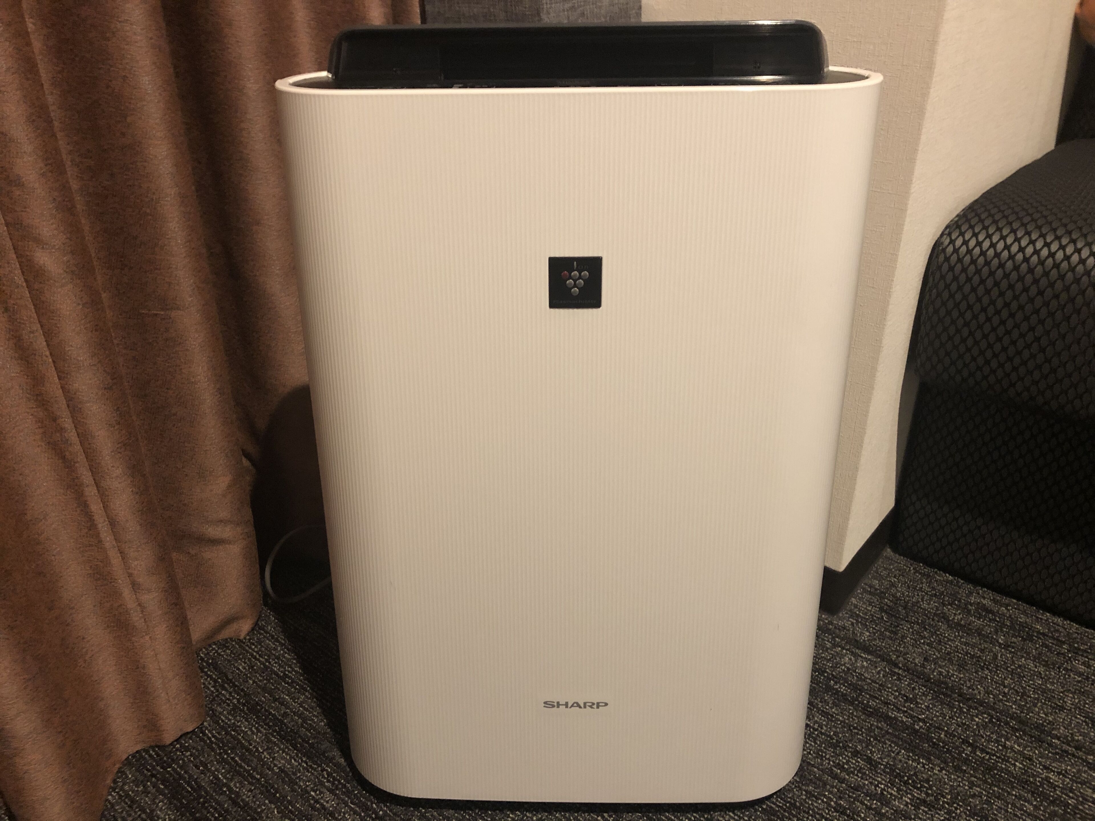 A white, ribbed, rectangular device with a black logo and the word "SHARP" on the bottom.